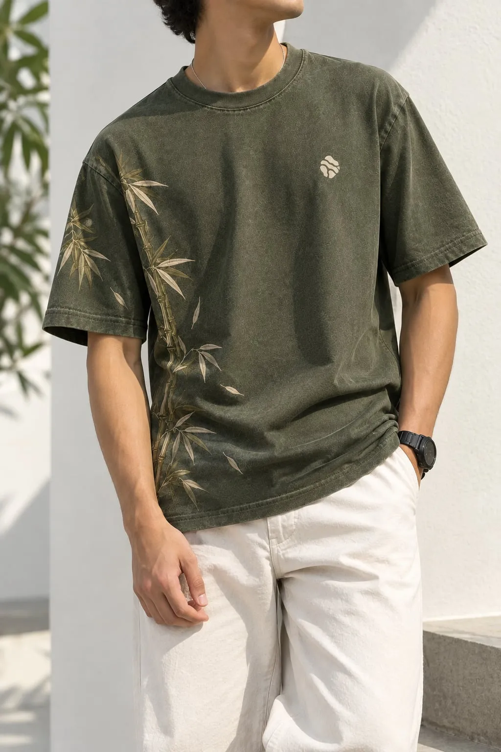 Model leaning against a white wall, wearing Bamboo Origin