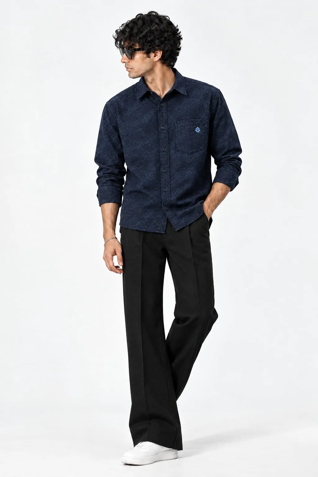 Model wearing the Storm Origin 01 navy shirt with black wide trousers